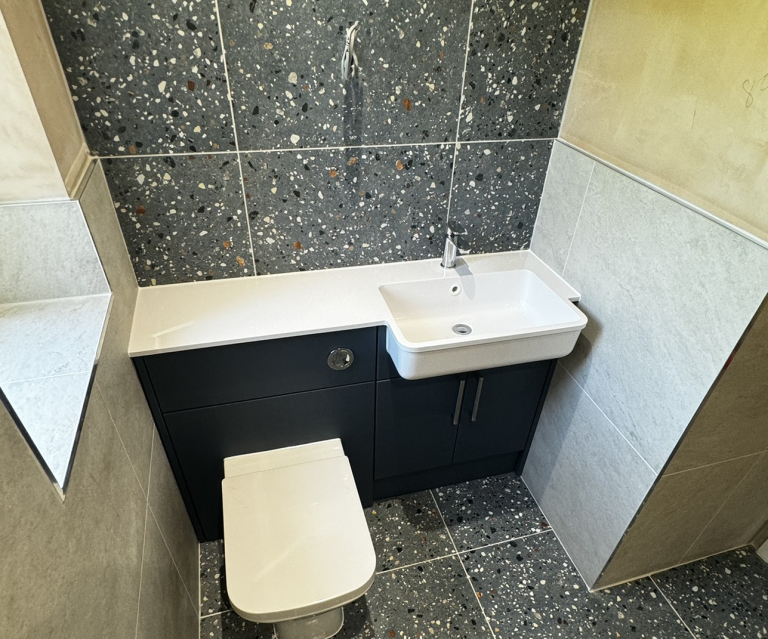 Modern Tiled Bathroom With Sink And Toilet